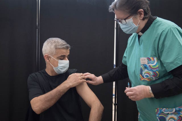 Mayor of London Sadiq Khan receives his first dose of the Pfizer vaccine from Dr Sue Clarke at a Covid-19 vaccination clinic at the Mitcham Lane Baptist Church, south London