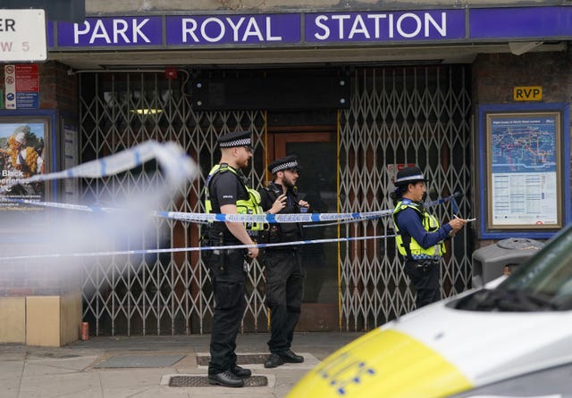 Police outside Park Royal underground station (PA)