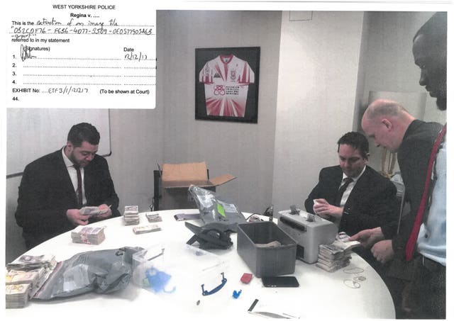 An image taken from video showing James Stunt’s late sibling Lee Stunt and other company staff counting allegedly laundered money in his brother’s office 