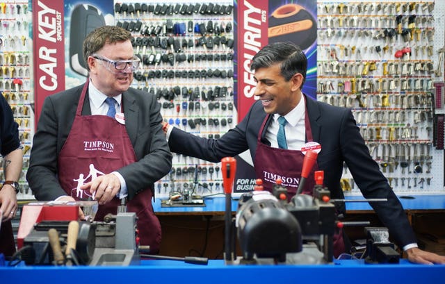 The Prime Minister, right, with Work and Pensions Secretary Mel Stride visiting a branch of Timpson after giving his policy speech on welfare reform
