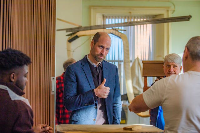 The Prince of Wales, known as the Duke of Rothesay when in Scotland, gives a thumbs-up during a visit to Carnoustie and Monifieth Men’s Shed, in Angus, to hear how the organisation is helping men and women build a sense of community and learn new skills 