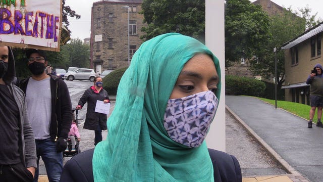 Hassan Ahmed's sister Safyah, who did not wish to give her surname, joined around 100 people for a demonstration outside Halifax police station (Dave Higgens/PA)