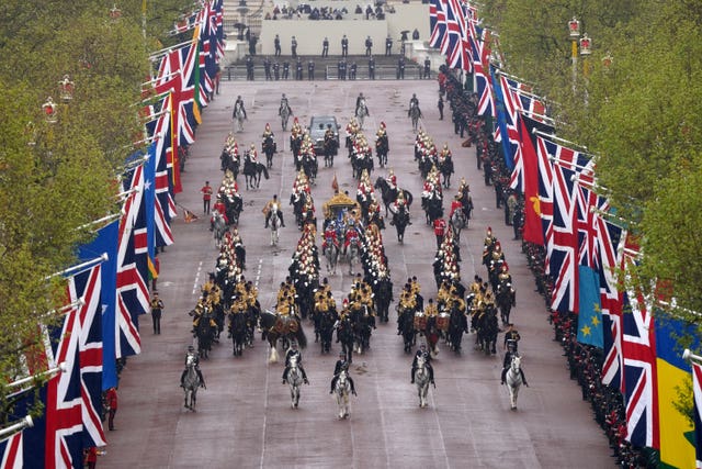 The Diamond Jubilee State Coach, accompanied by the Sovereign’s Escort of the Household Cavalry 