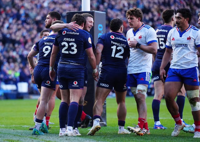 Tom Jordan, centre left, celebrates scoring a try with Finn Russell 