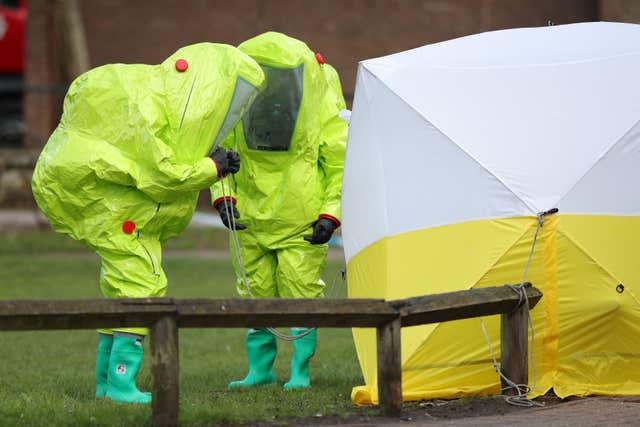Officers in hazmat suits secure a tent covering a bench in the Maltings shopping centre in Salisbury (Andrew Matthews/PA)