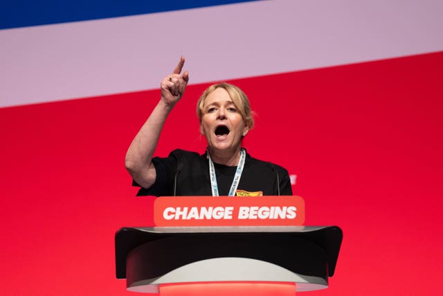 Sharon Graham pointing into the air while speaking from a lectern