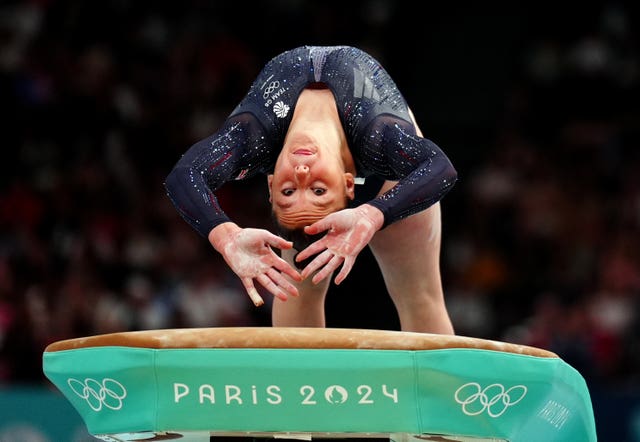 Gymnast Abi Martin, upside down, goes head first on to a vault. 