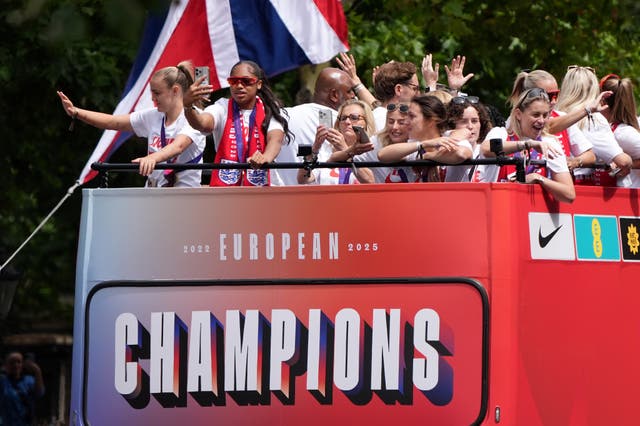 England manager Sarina Wiegman and players take photos from the bus