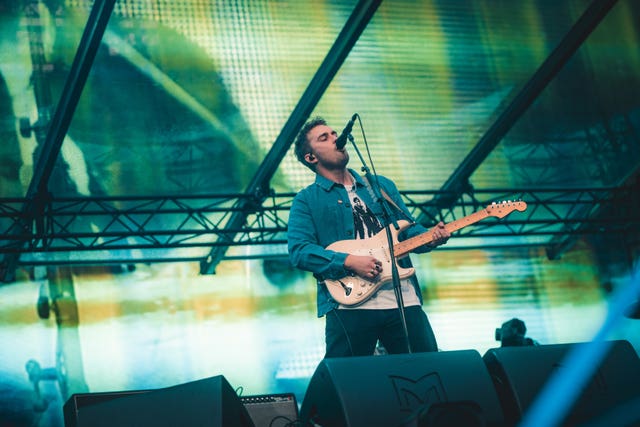 Sam Fender performing on stage at St James’ Park