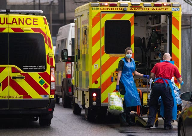 Paramedics unload a patient from an ambulance outside the Royal London Hospital