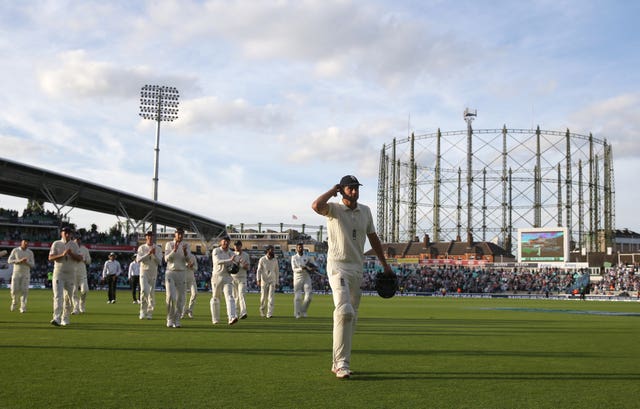 Alastair Cook leads the players off