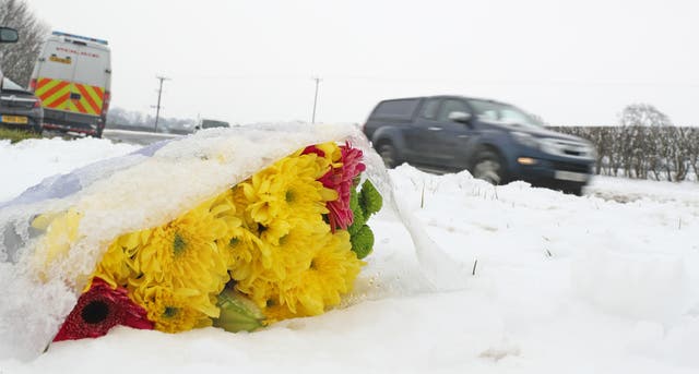 Flowers at the scene on the A61 near Thirsk (Owen Humphreys/PA)