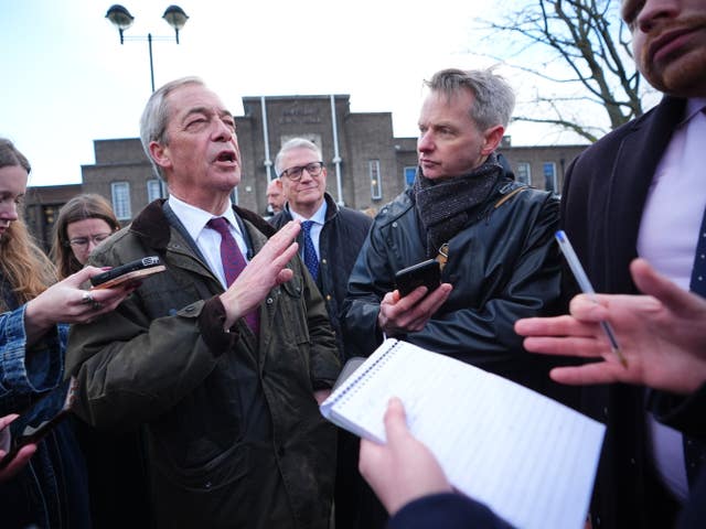 Nigel Farage surrounded by reporters near Romford