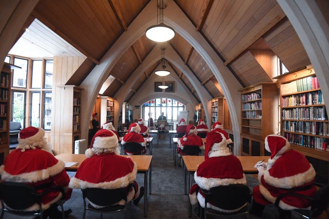 Father Christmas performers in a classroom during the 23rd annual Santa School