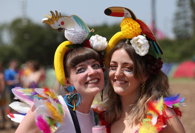 Festival goers in the hot weather on the third day of the Glastonbury Festival at Worthy Farm in Somerset 