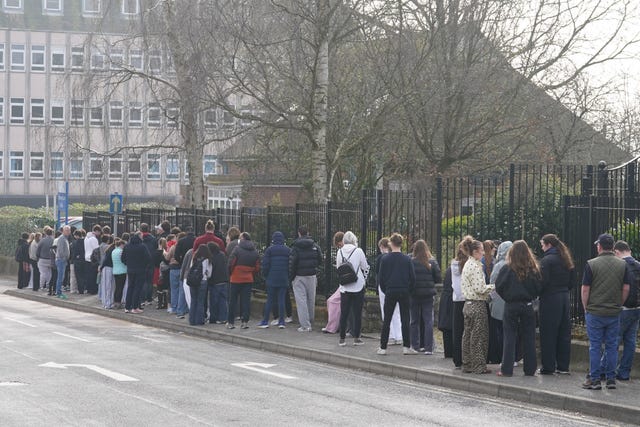 Young people in a large queue outside