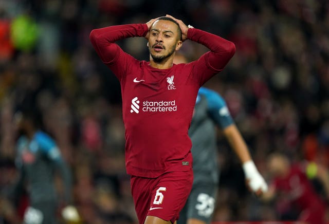 Alcantara in an all-red Liverpool kit with his hands on his head in frustration