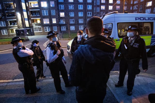 Police officers and special constables talk to a suspect following a stop and search in Walworth, Southwark (Victoria Jones/PA)