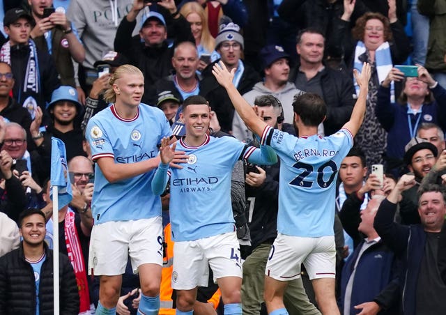 Phil Foden (centre) celebrates scoring the sixth with Erling Haaland 