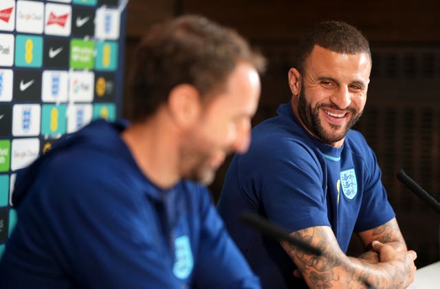 Kyle Walker, right, and manager Gareth Southgate laugh together during an England press conference