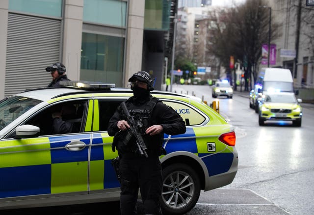 Armed police escort a van into Manchester Crown Court for the trial 