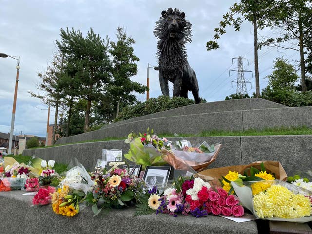 Flowers left at the statue of Aslan the lion at CS Lewis Square in east Belfast 