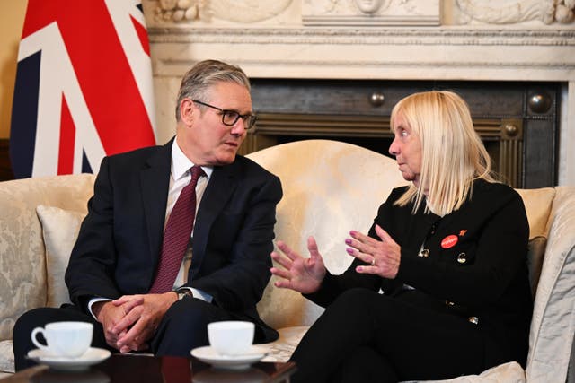 Prime Minister Sir Keir Starmer speaks with Margaret Aspinall