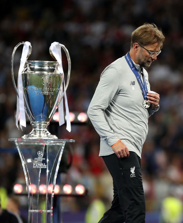 What might have been for Jurgen Klopp as he walks past the Champions League trophy after collecting his loser's medal