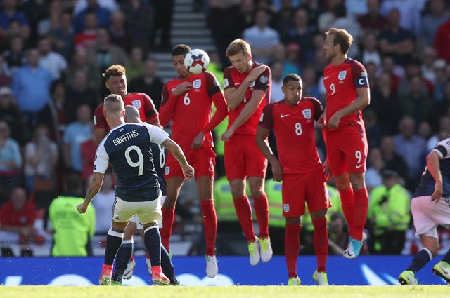 Leigh Griffiths bends his second goal of the game against England.