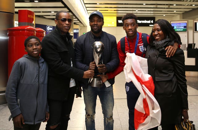 Hudson-Odoi shares the World Cup Under-17 trophy with his family on his successful return from the tournament.