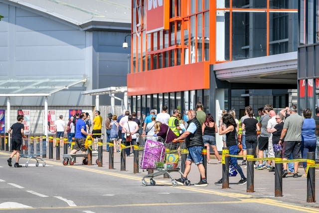 B&Q re-opened many of its stores this week and people were pictured waiting to enter (Ben Birchall/PA)