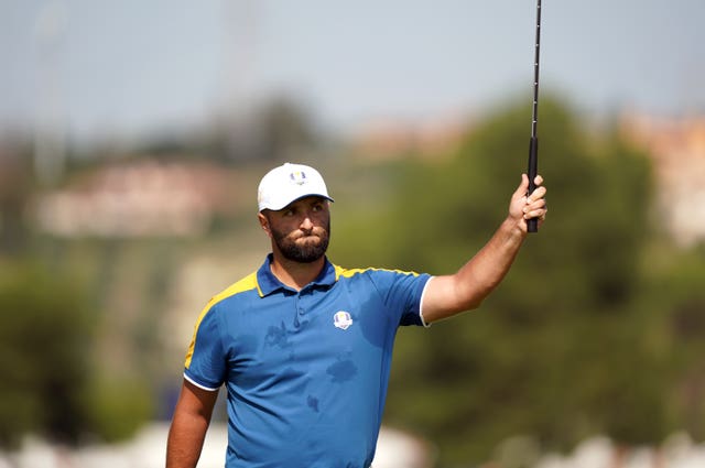 Jon Rahm celebrates winning the first hole against Scottie Scheffler