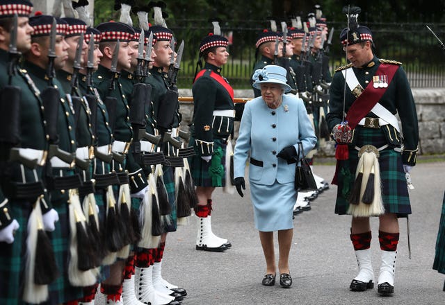 The Queen inspects the Balaklava Company, 5 Battalion The Royal Regiment of Scotland at the gates at Balmoral, as she took up summer residence in 2019