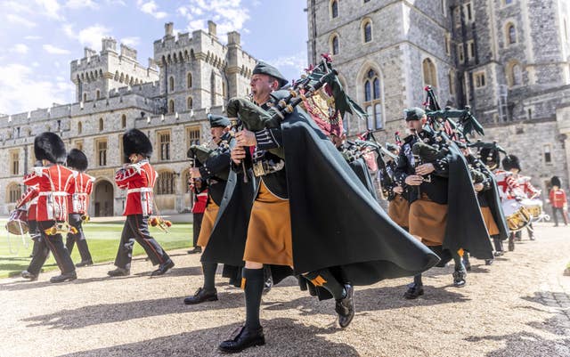 Pipers of the 1st battalion Irish Guards march into the Quadrangle of Windsor Castle where new regimental colours were presented to the regiment by the Duke of Cambridge
