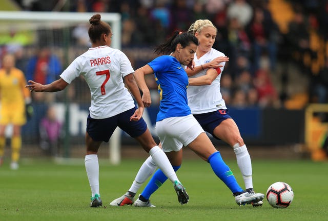 England’s Nikita Parris (left) and Steph Houghton (right) in action against Brazil. (PA)
