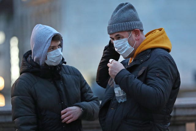 People wearing face masks in Trafalgar Square, London (Yui Mok/PA)
