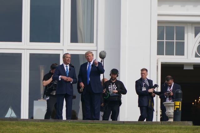 Former US president Donald Trump and Nigel Farage with a TV crew in the background