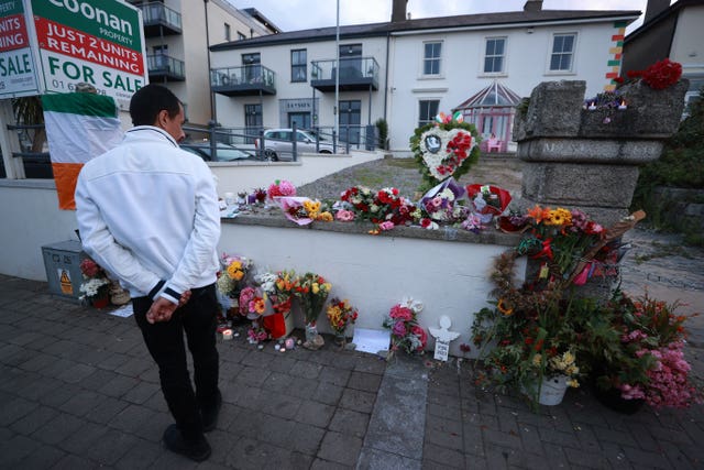 A man looks at flowers outside Sinead O’Connor’s former home in Bray, Co Wicklow