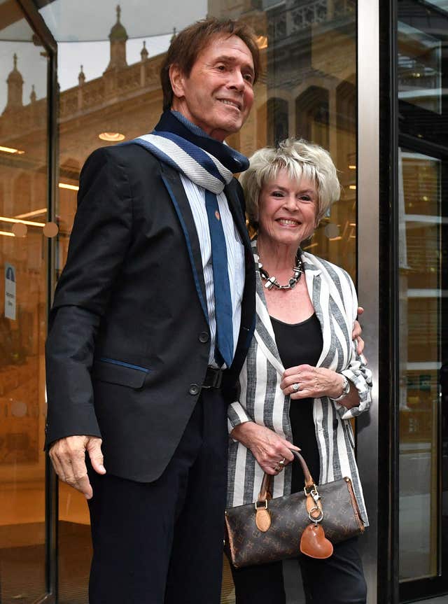 Sir Cliff Richard leaves the building with Gloria Hunniford, where the case is being heard (Dominic Lipinski/PA)
