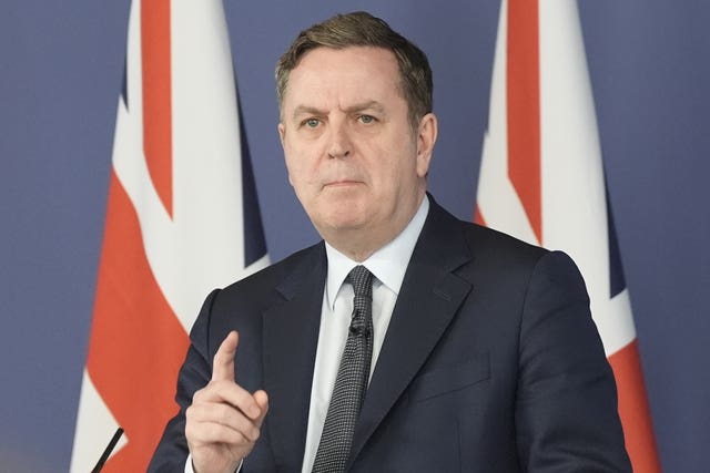 Shadow chancellor Sir Mel Stride delivers a speech in front of Union flags