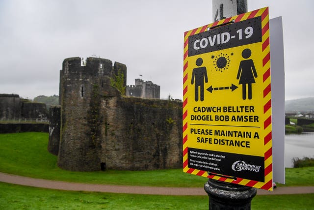 Covid-19 signage opposite Caerphilly castle (Ben Birchall/PA)