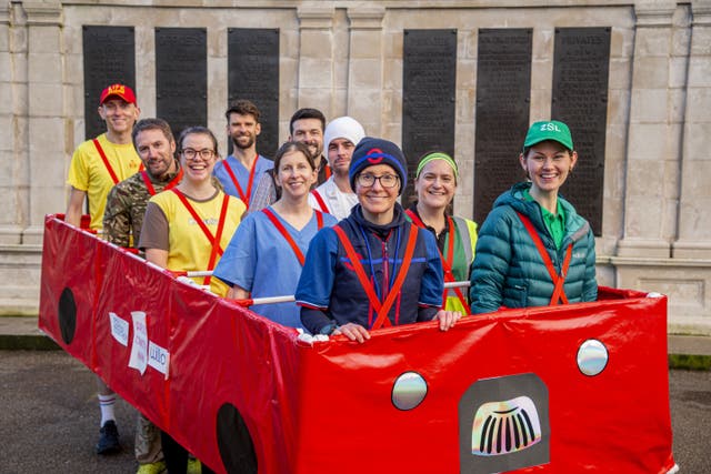 Jackie Scully, front left, in her 10-person costume of a red bus at the London Marathon