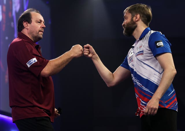 Lowe, left, defeated Dmitriy Gorbunov in the PDC World Championship first round (Kieran Cleeves/PA)