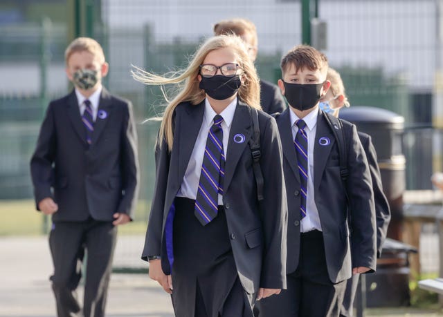Pupils wear protective face masks