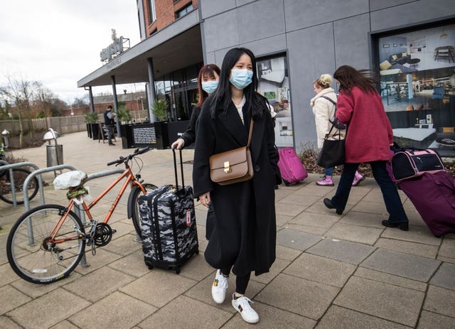 Two women wearing face masks leave the Staycity Hotel in York