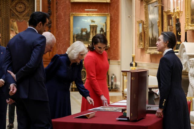 The King and Queen with the Emir of Qatar Sheikh Tamim bin Hamad Al Thani (left) and his wife Sheikha Jawaher (right) at a display of Qatari items from the Royal Collection at Buckingham Palace