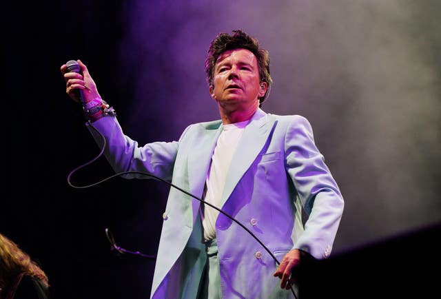 Rick Astley performing on stage at the Glastonbury Festival