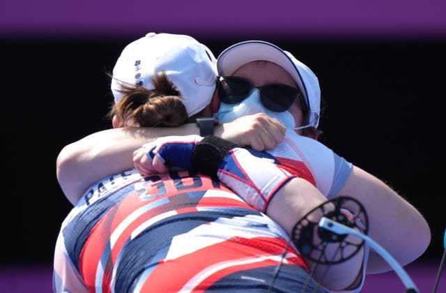 Great Britain’s Phoebe Paterson Pine, back to camera, is congratulated by Jess Stretton