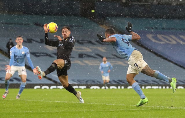 Aston Villa’s Matty Cash, centre left, commits a handball against Manchester City