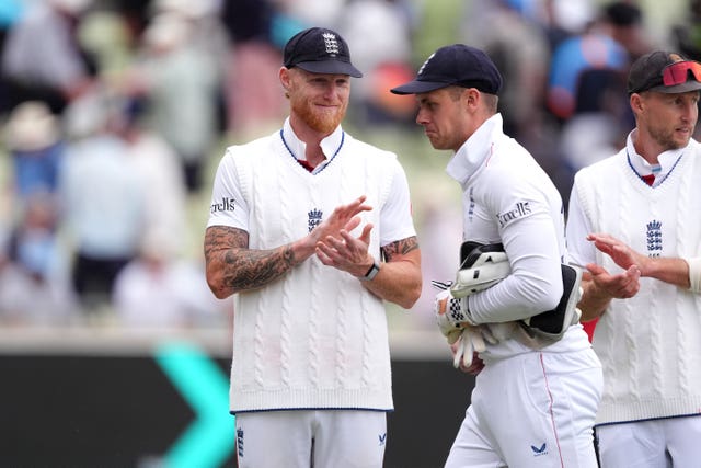 England captain Ben Stokes, left, applauds team-mate Jamie Smith as the players leave the field